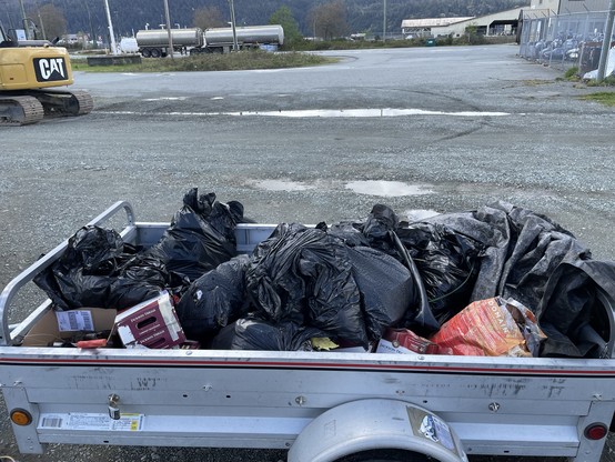 A small trailer full of garbage.