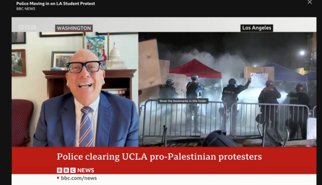 Screenshot from BBC of some guy talking loudly defending Biden and calling protesters “anarchists”