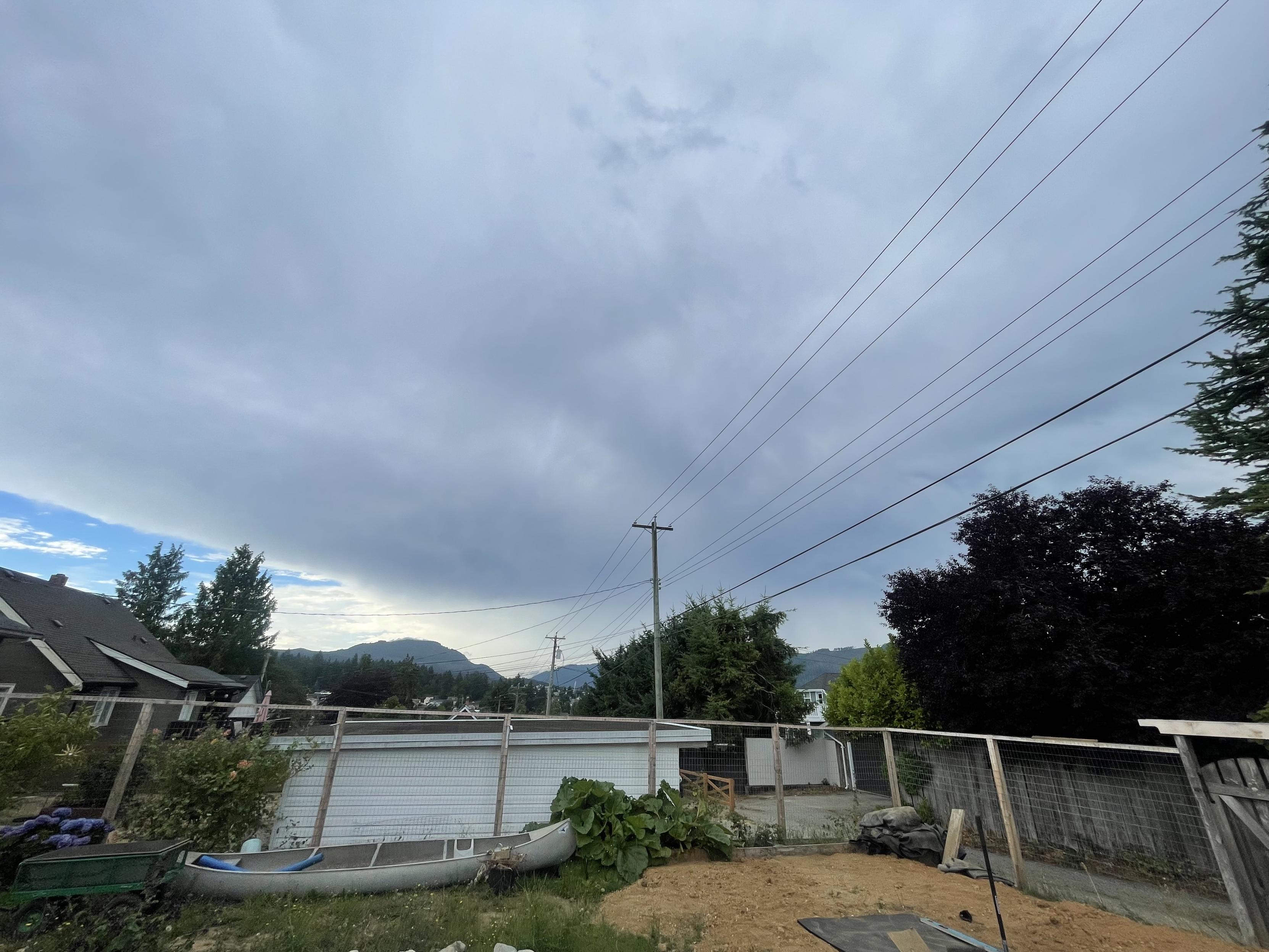i'll look at the sky shows a large, massive white gray cloud sharp line to the southeast bottom left corner of the picture where a sliver of blue remains